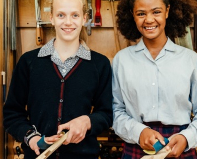 two kids with sanding wood